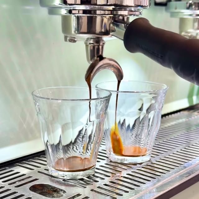 Espresso pouring into two glasses